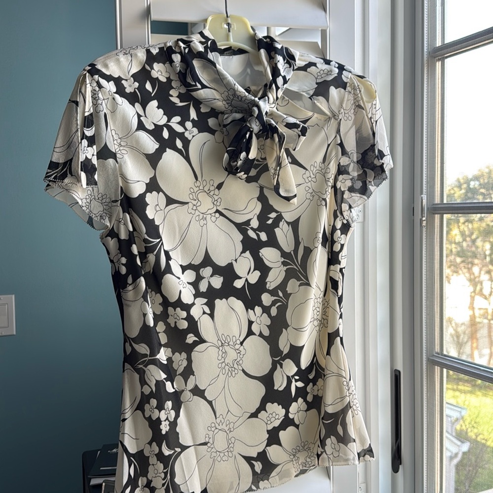 Silk black and cream flowered blouse with capped sleeves.